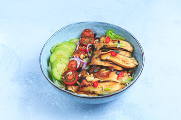 Salad bowl with roaster king oyster mushrooms, tomato, cucumber and red onion