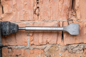 hammer drill on brick background