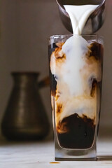 cold coffee with milk and ice, close up