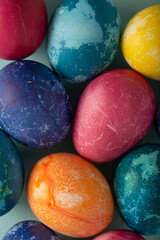 Multicolored Easter eggs on a blue background, close up