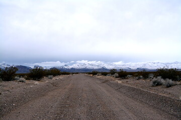 Titus Canyon road winding one way from Nevada to California in the Amargosa Mountains, Death Valley National Park on a snowy day in December