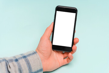 Hands use mobile phone, copy space, blue background