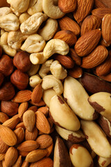 Obraz premium Different nuts on whole background, close up