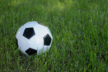Fototapeta na wymiar Soccer ball on a grass football field