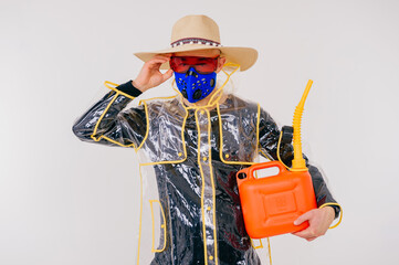 Funny stylish strange man in the mask and straw hat with watering pot posing over white background