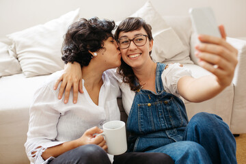 Affectionate lesbian couple taking selfie
