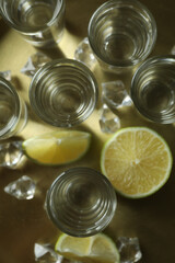 Tray with shots, lime slices and ice cubes, top view