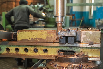 The work of the milling machine close-up. On the background of the workers