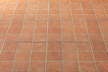 The modern brown concrete tile floor background and texture