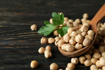 Spoon with fresh chickpea on wooden table