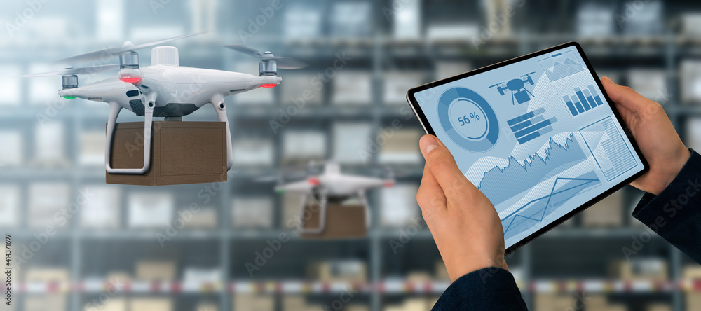 Poster Warehouse manager with digital tablet controls drone with a package. Unmanned delivery concept