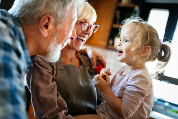 Happy grandparents having fun times with children at home