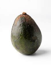 Avocado isolated on a white background, rough and thick skin, the flesh of the avocado is creamy and soft with a buttery taste. Avocados contain nutrients, vitamins and good fats.
