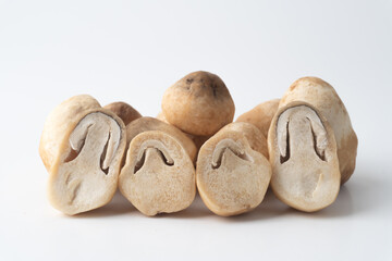 Pile of  straw mushroom on a white background, half straw mushroom.