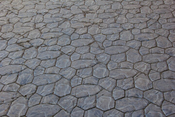 Sidewalks are laid out with tiles of a chaotic shape.