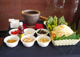 Papaya salad ingredients and terracotta mortar
