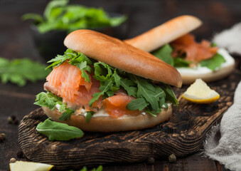 Organic healthy sandwiches with salmon and bagel, cream cheese and wild rocket and lemon