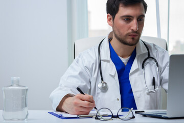 a doctor taking notes from the laptop