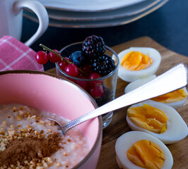 vegetarian breakfast with millet porridge, berries and eggs
