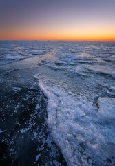 Beautiful ice floes on the lake Ijsselmeer in the Netherlands during sunrise.