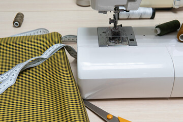 tailor's workplace, sewing machine, measuring tape, scissors, thread.The concept is small business, creativity.Close-up