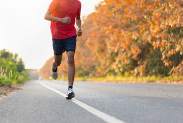 man runner athlete on the road to healthy, Young people running exercise on street.