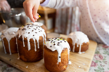 Kid help mom decorate Traditional eastern europe Russian and ukrainian Easter cake kulich decorated...