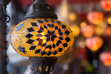 Closeup of traditional oriental pendant lamp in shop, with others in soft focus background
