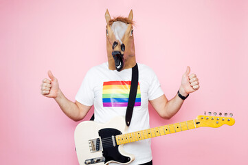 Man with euphoric horse head and fingers up.