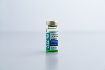 ampoules or vials with Covid-19 vaccine on a laboratory bench. SARS-CoV-2 Vaccination, immunization, treatment to cure Covid 19 Corona Virus infection. Medical concept.