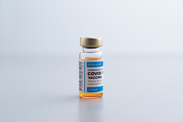 ampoules or vials with Covid-19 vaccine on a laboratory bench. SARS-CoV-2 Vaccination, immunization, treatment to cure Covid 19 Corona Virus infection. Medical concept.