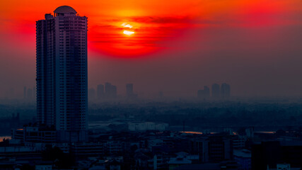 The blurred abstract background of the morning sun exposure to the tiny dust particles that surround the tall buildings in the capital, the long-term health issue of pollution