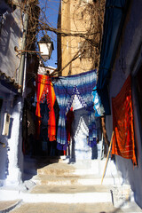 colorful street and cloth at Chefchaouen, Morocco 
