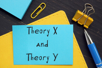  Financial concept about Theory X and Theory Y with phrase on the piece of paper.