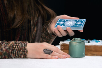 Fortune teller is reading the future with tarot cards close up.