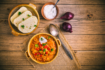 Hungarian Szegedin Goulash with pickled white cabbage (sauerkraut) and bread dumplings