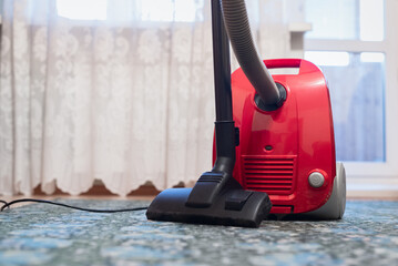 Vacuum cleaner on the floor. Home cleaning concept background.