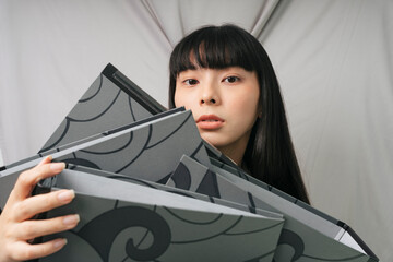 Busy businesswoman with overload work carrying file folder.
