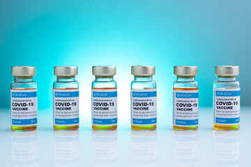ampoules or vials with Covid-19 vaccine on a laboratory bench. SARS-CoV-2 Vaccination, immunization, treatment to cure Covid 19 Corona Virus infection. Medical concept.