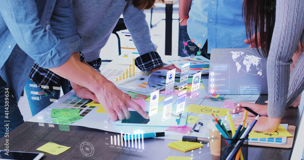 Poster Close up ux developer and ui designer use augmented reality app brainstorming about mobile interface wireframe design on desk at modern office.Creative digital development agency