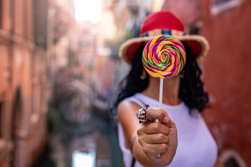 Tourist family members are having fun with lollipop at Venice Italy.