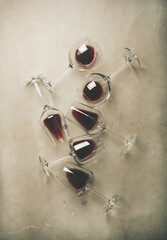 Flat-lay of red wine in glasses over grey concrete background, top view. Bojole nouveau, wine bar,...