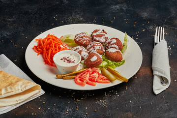 Vegetarian falafels and vegetables on a plate