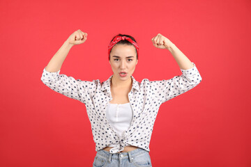 Strong woman as symbol of girl power on red background. 8 March concept