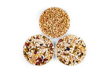 Different cereals in a round bowl on a white background