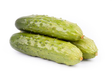 three whole cucumbers on a white background