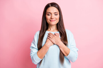 Photo of peaceful dreamy mature woman wear blue pullover arms chest closed eyes isolated pink color background
