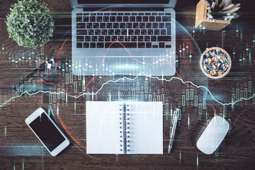 Stock market graph and top view computer on the table background. Multi exposure. Concept of financial education.