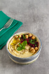 A classic oriental appetizer dish - chickpea hummus with beetroot salad, olive oil and parsley