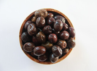 black canned olives in a wooden plate